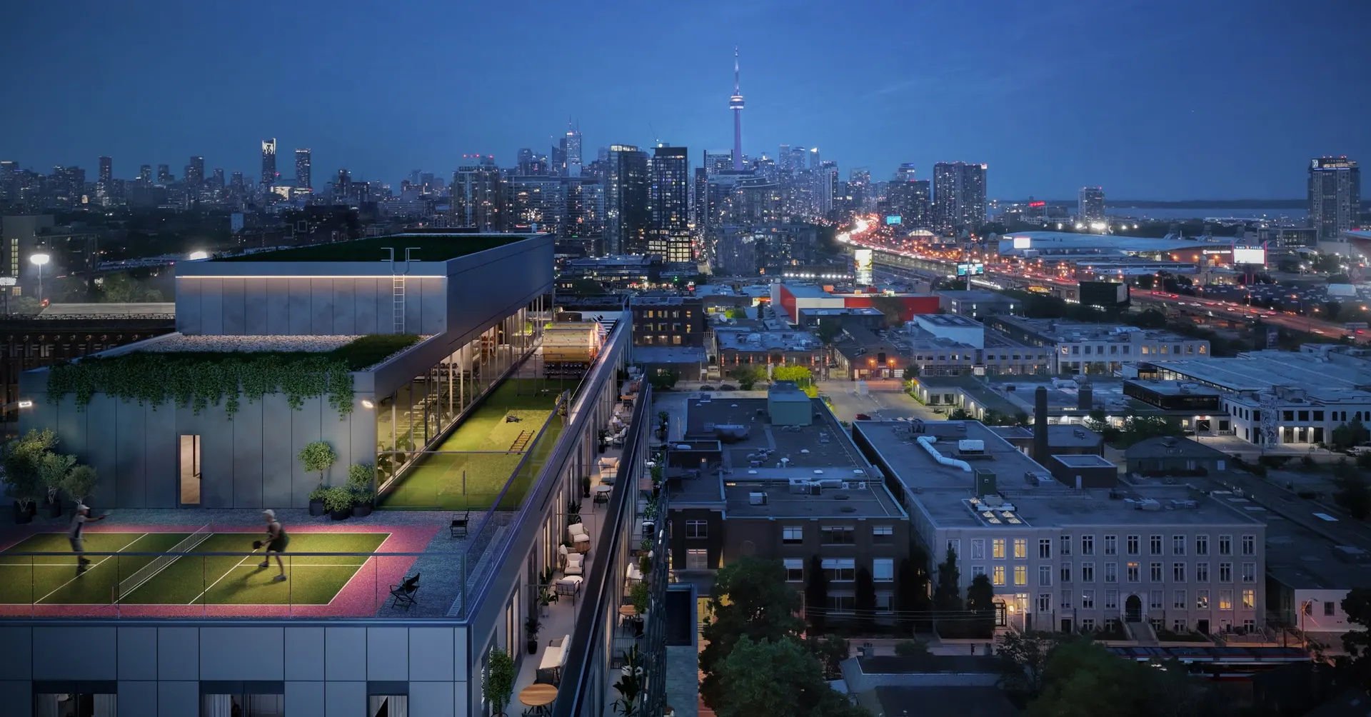 Artist's concept of the 8 Temple rooftop at night, with the pickleball court and lounge overlooking the downtown skyline